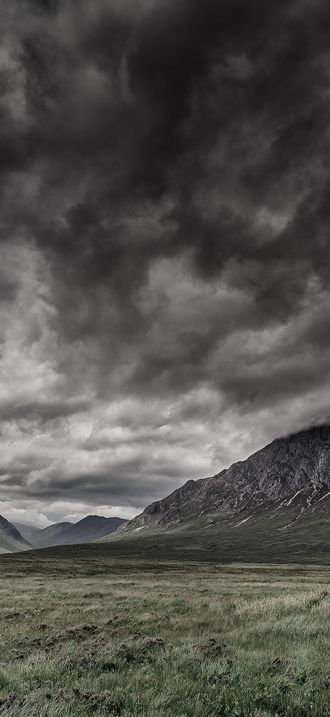 Dark clouds above the hilly valley