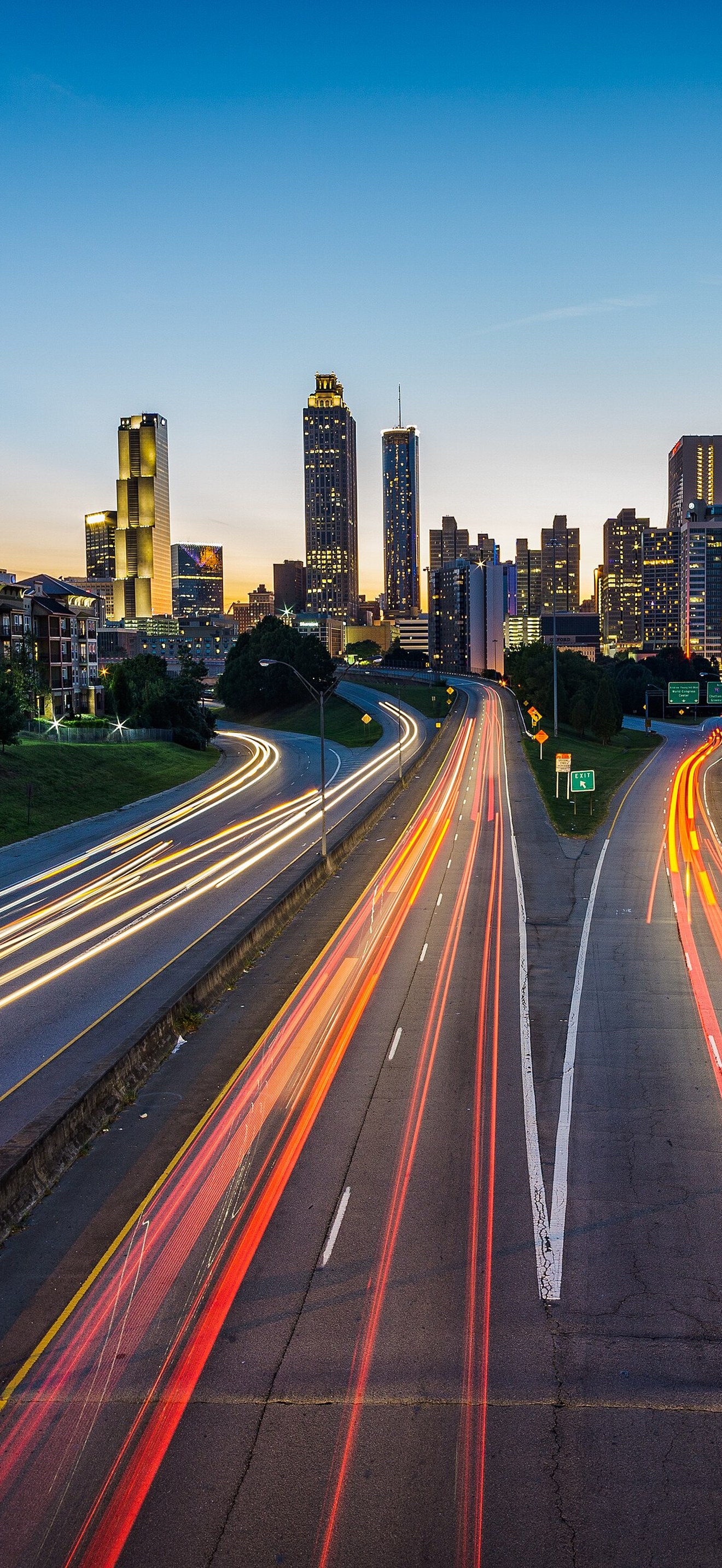 Long exposure of highway and skyscraper with bright sky