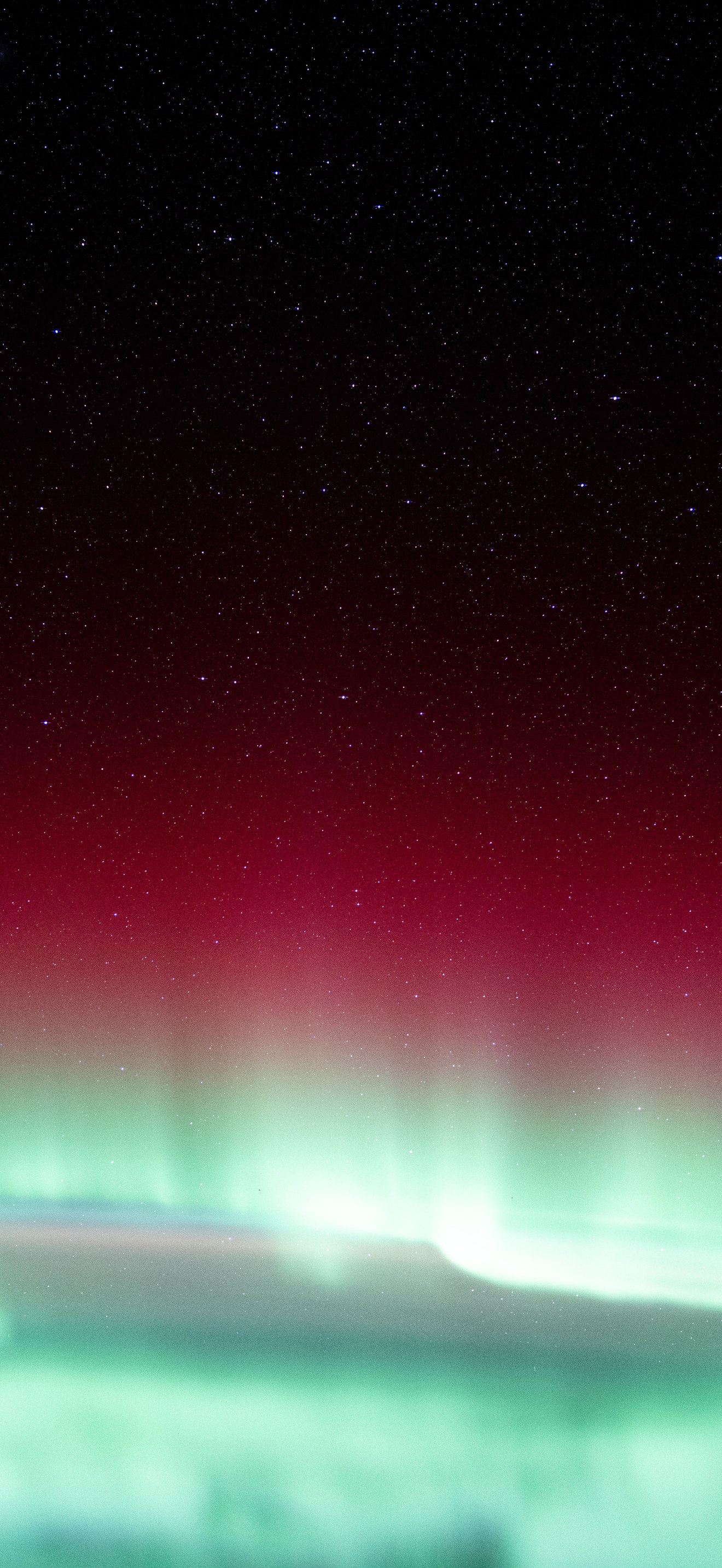 A red and green aurora borealis above Canada's Gulf of St. Lawrence
