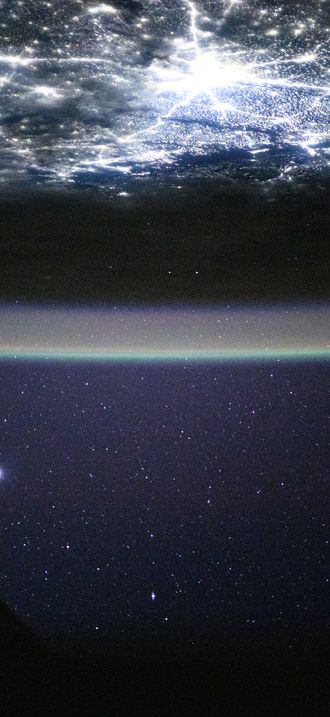 The city lights of New Delhi, India, underneath a starry night sky