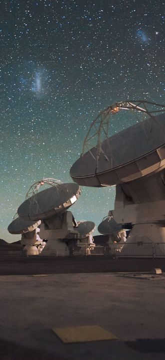 The Atacama Large Millimeter/submillimeter Array (ALMA) by night, under the Magellanic Clo