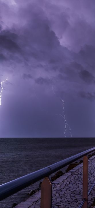 Port and lighthouse overnight storm with lightning in Port-la-Nouvelle