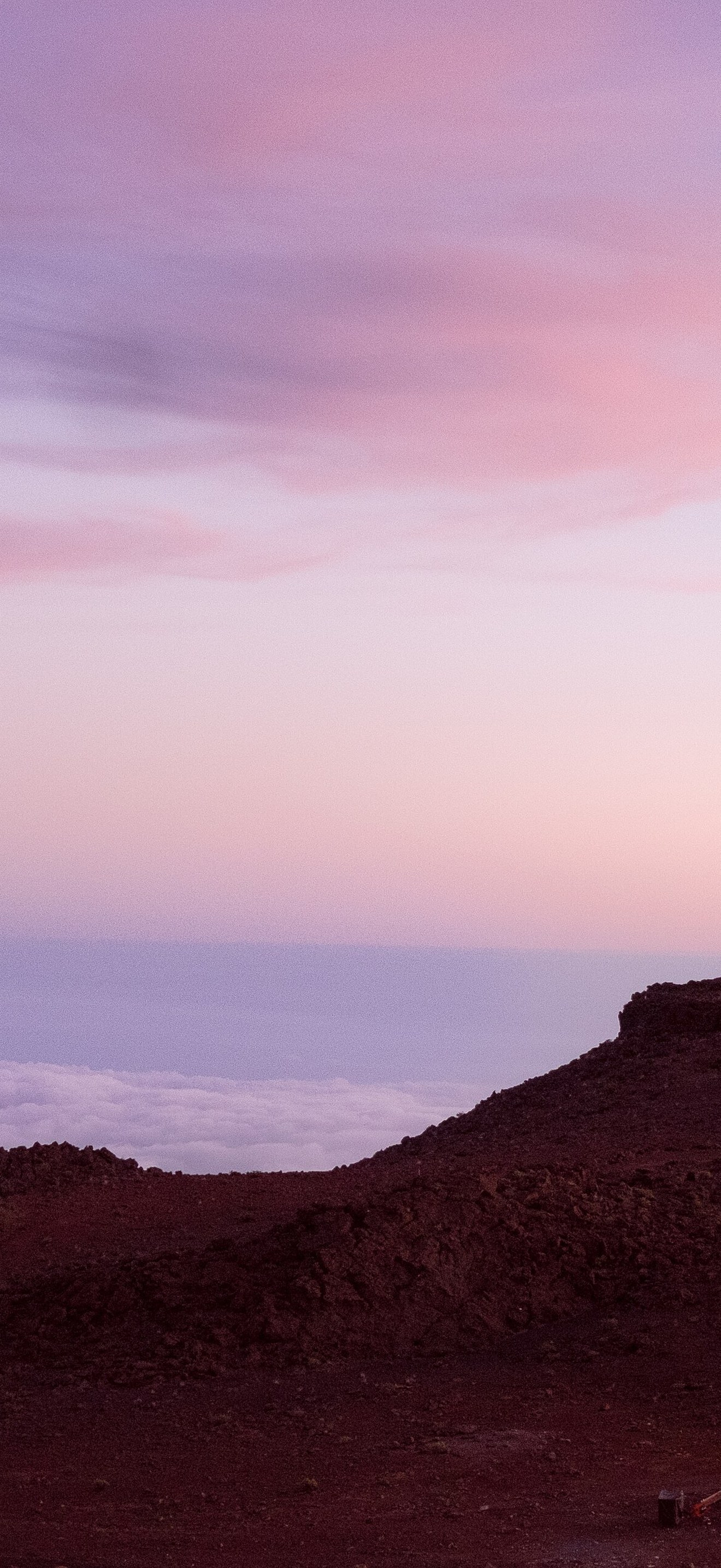 Haleakala Observatory above sunset clouds (Unsplash)