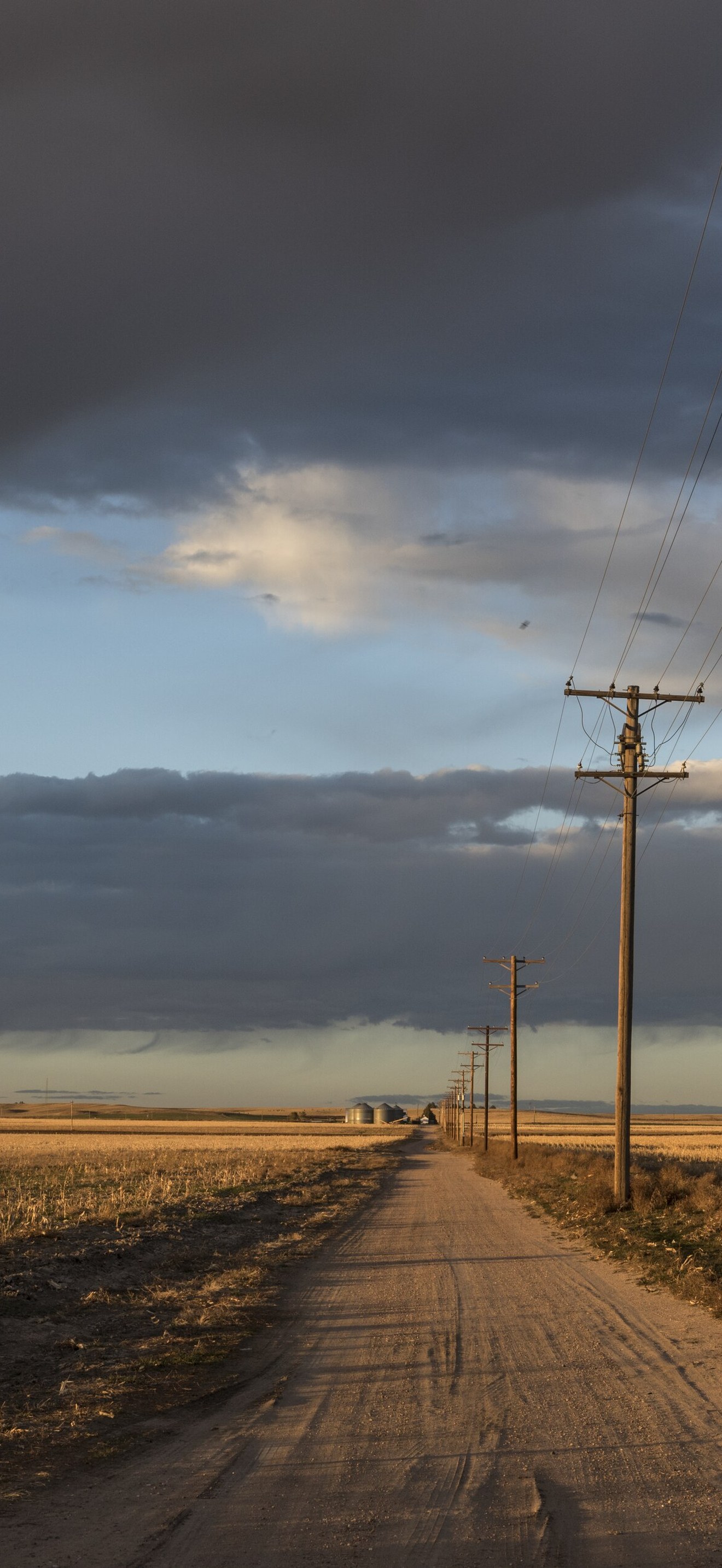 Dusk approaches along a dusty road in Sedgwick County, near Julesburg, Colorado